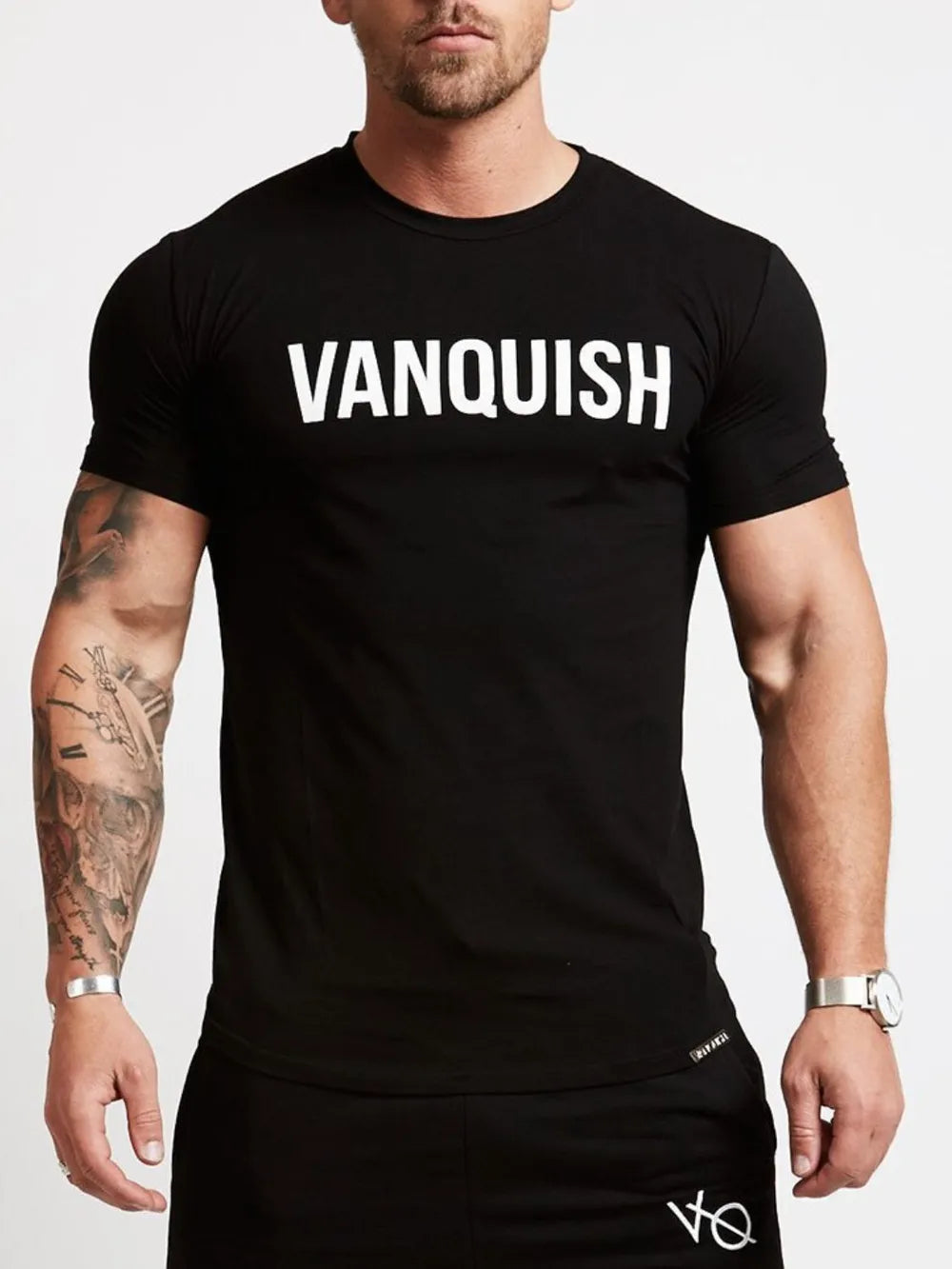 Black crew neck t-shirt with white VANQUISH graphic, short sleeves, and a casual fit.
