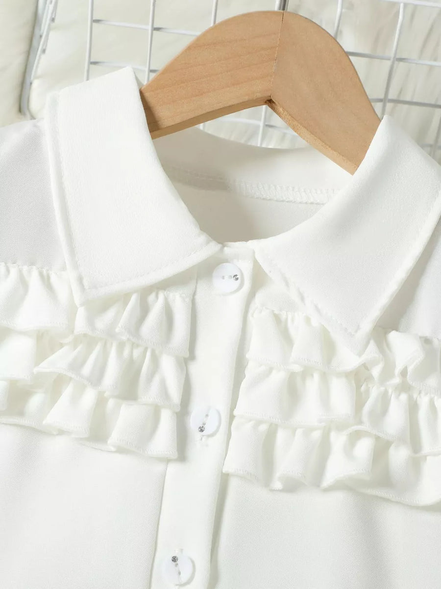 White baby top with ruffled front and button closure