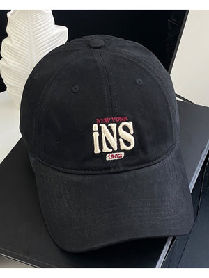 Black baseball cap with embroidered New York INS 1962 detail