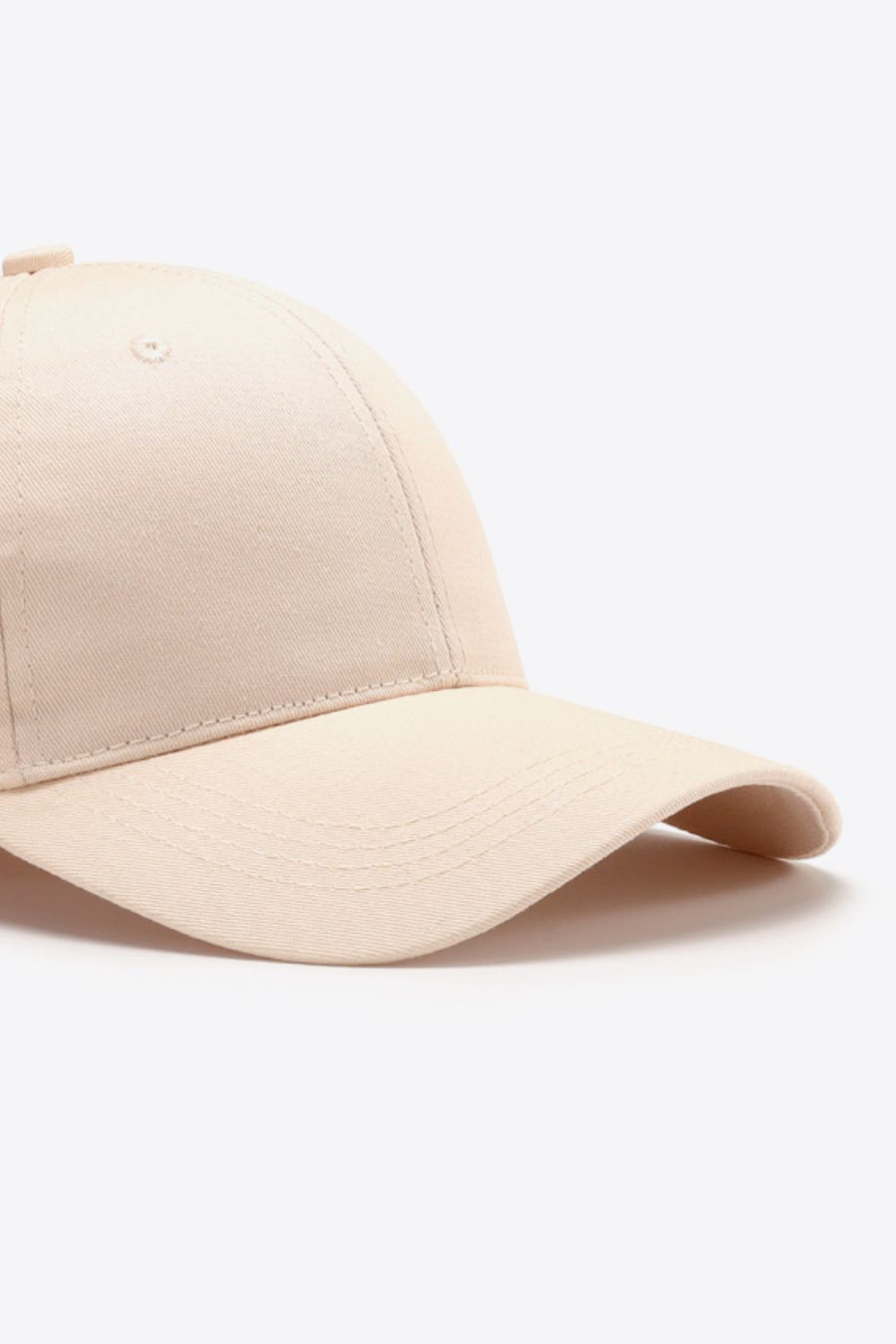 Cream cotton twill baseball cap with curved brim and stitched details.