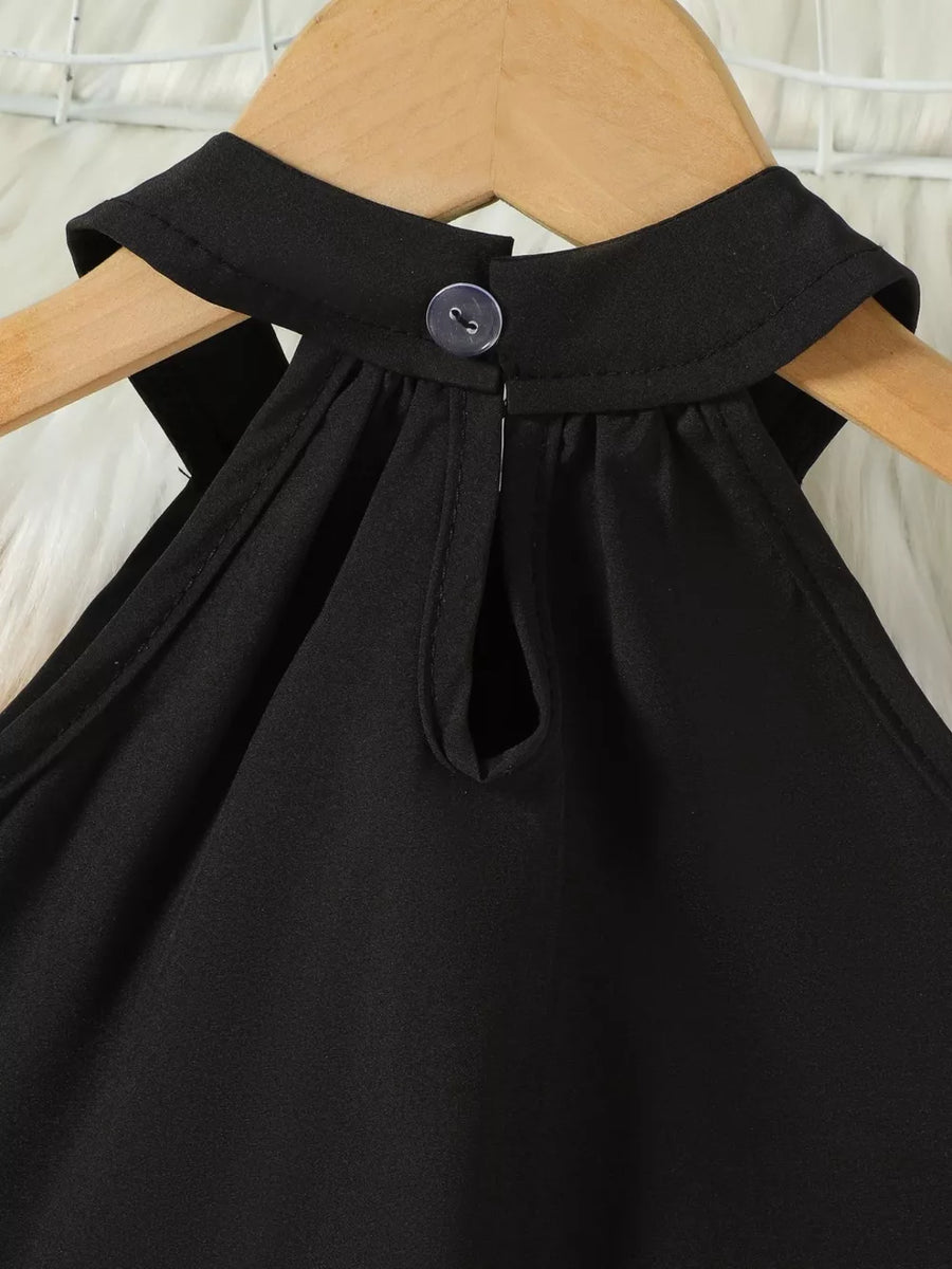 Black toddler top with halter neck, cutout detail, and button closure.