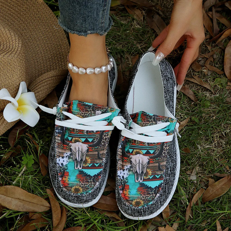 Embroidered canvas slip-on flats with bull skull and floral print, rope detail.