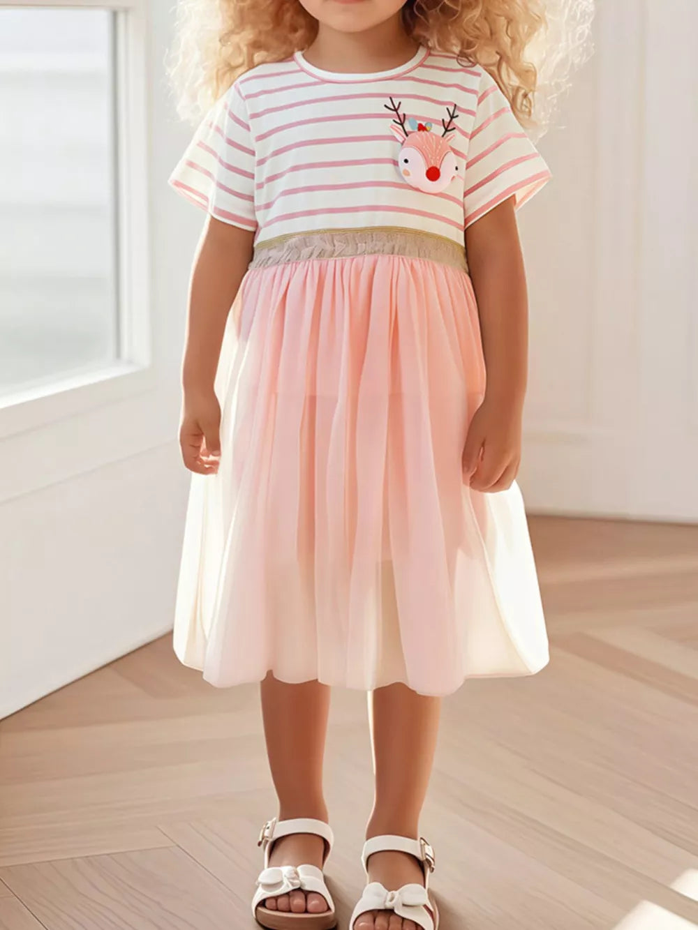 Girls pink striped dress with reindeer applique and tiered tulle skirt.