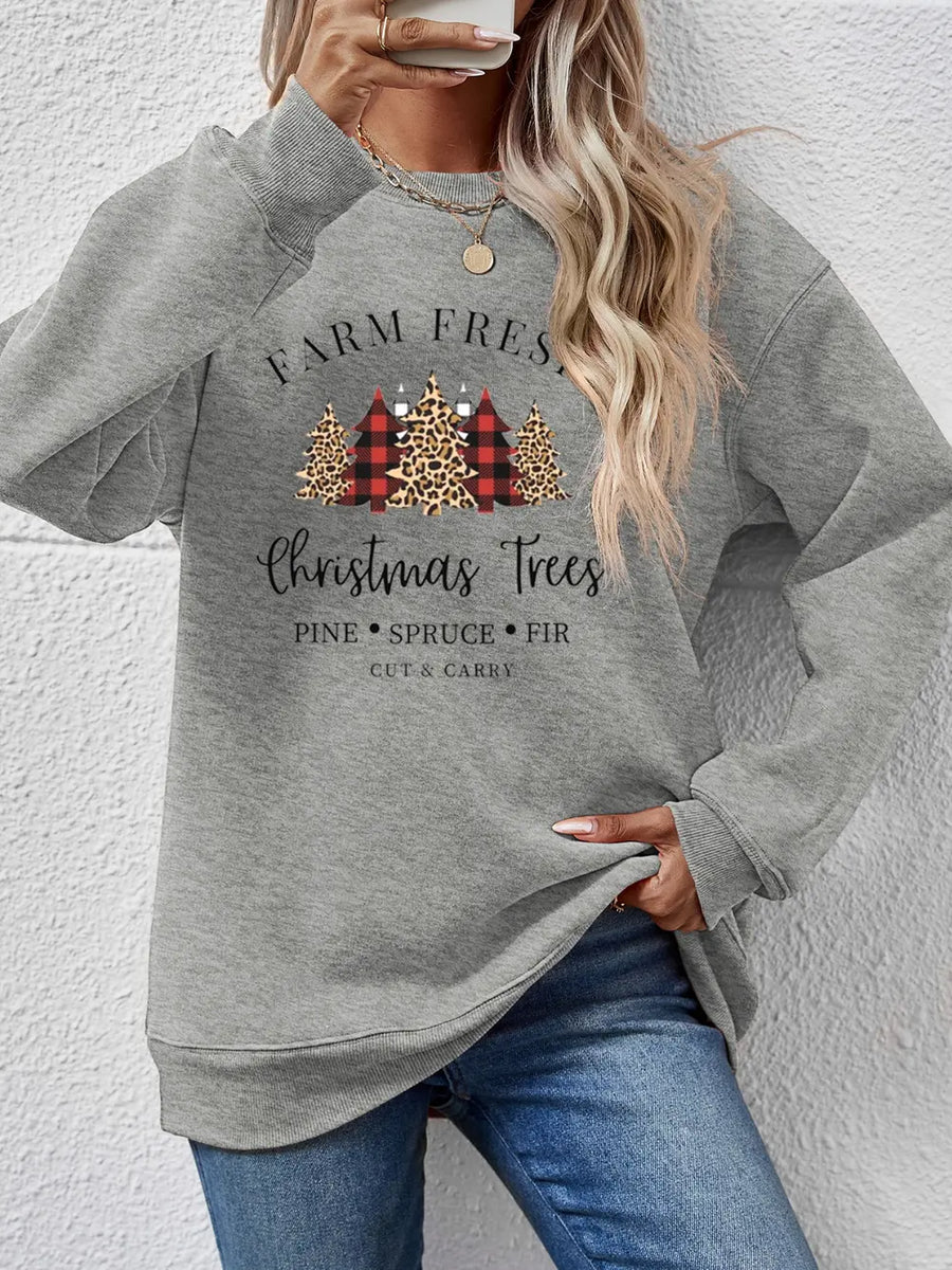Crewneck sweatshirt in Misty Blue with Christmas trees graphic and text.