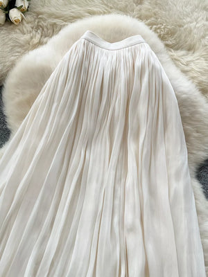 Cream pleated maxi skirt with a flowy, elegant cut.