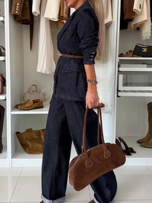 Dark navy high-waisted wide-leg jeans in denim, cuffed at the hem.