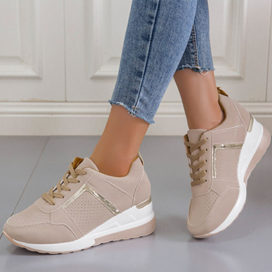 Beige lace-up wedge sneakers with metallic accents and perforated details.