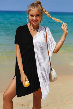 Crochet beach cover-up with black and white split design, V-neck, short sleeves, and side slits.