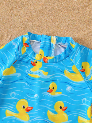 Baby swimsuit with yellow ducks on blue water pattern, long sleeves, and zipper closure.