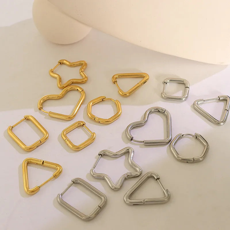 Geometric steel huggie earrings in gold and silver star, heart, triangle, square, and rectangle shapes.