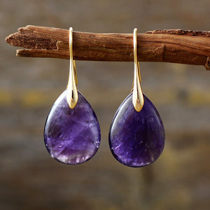 Violet gemstone teardrop leverback earrings with gold accents.
