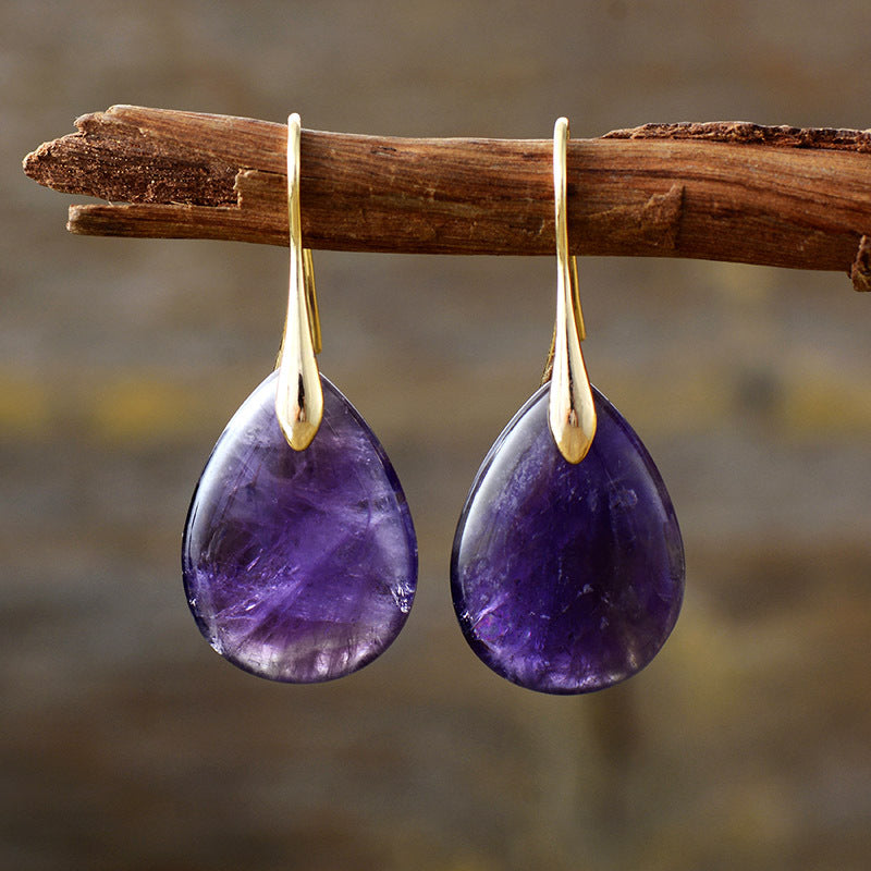 Violet gemstone teardrop leverback earrings with gold accents.