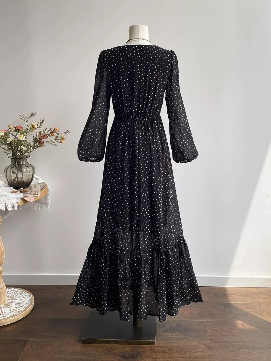 Black embroidered floral maxi dress with long sleeves and tiered hem.