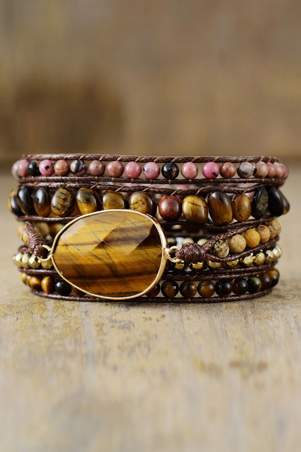 Wrap bracelet stack with tiger eye stone and brown cord, featuring assorted beads.