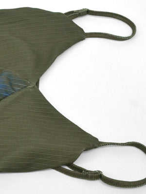 Botanical print spaghetti strap maxi dress in green with textured fabric and blue floral detail.