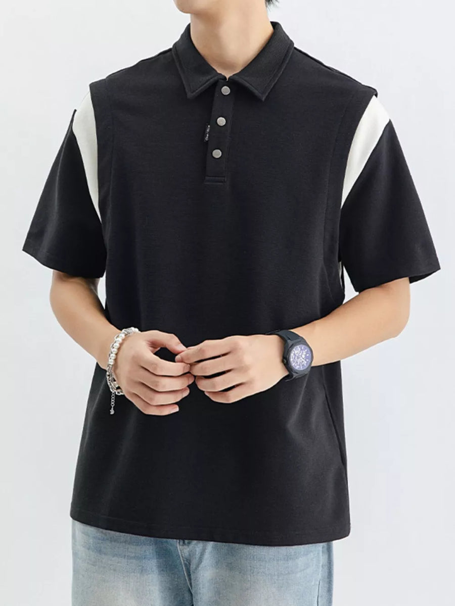 Black cotton polo shirt with contrast white shoulder panels and buttoned placket.