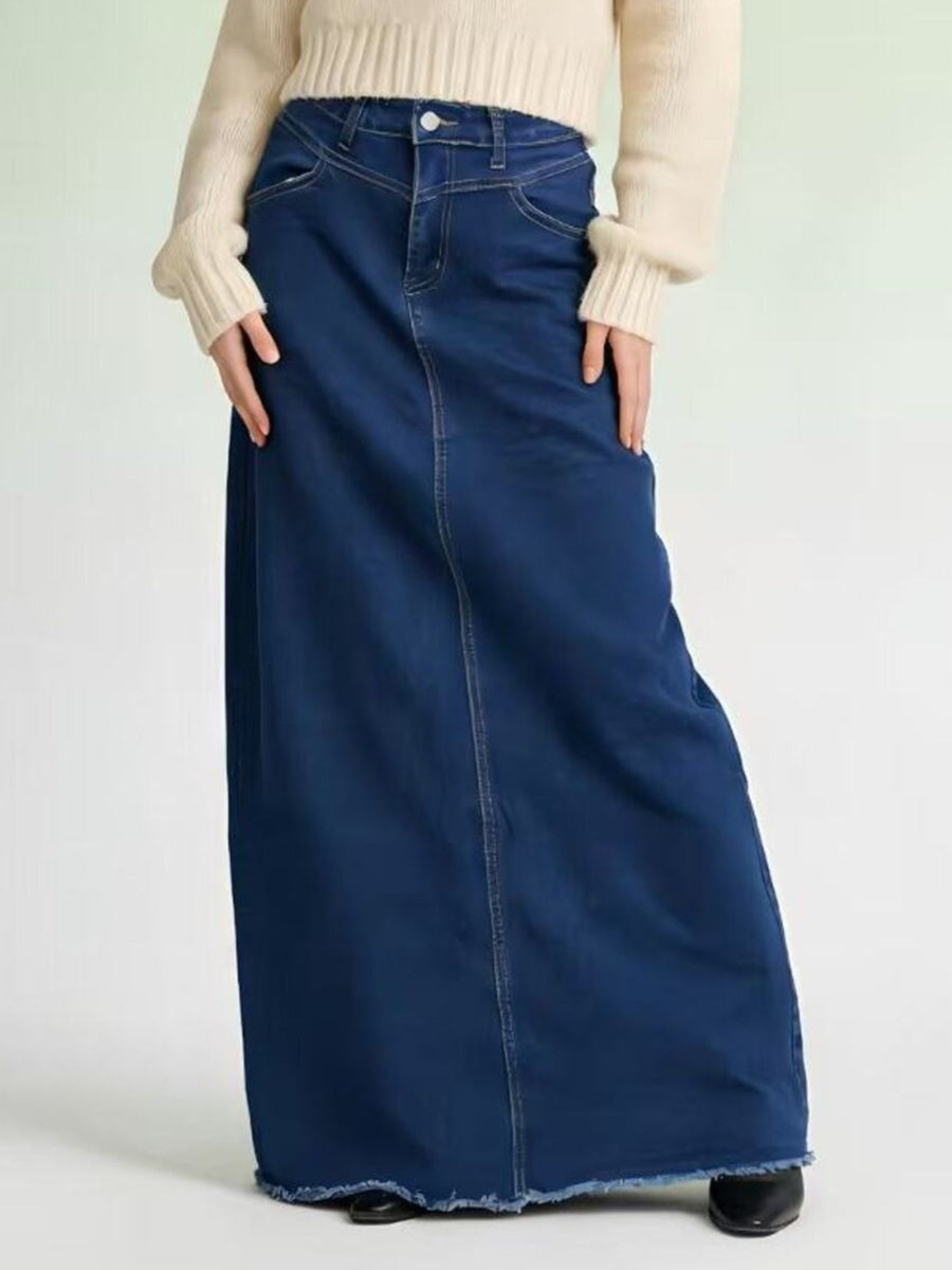 Dark blue denim maxi skirt with raw hem and button closure, cotton.