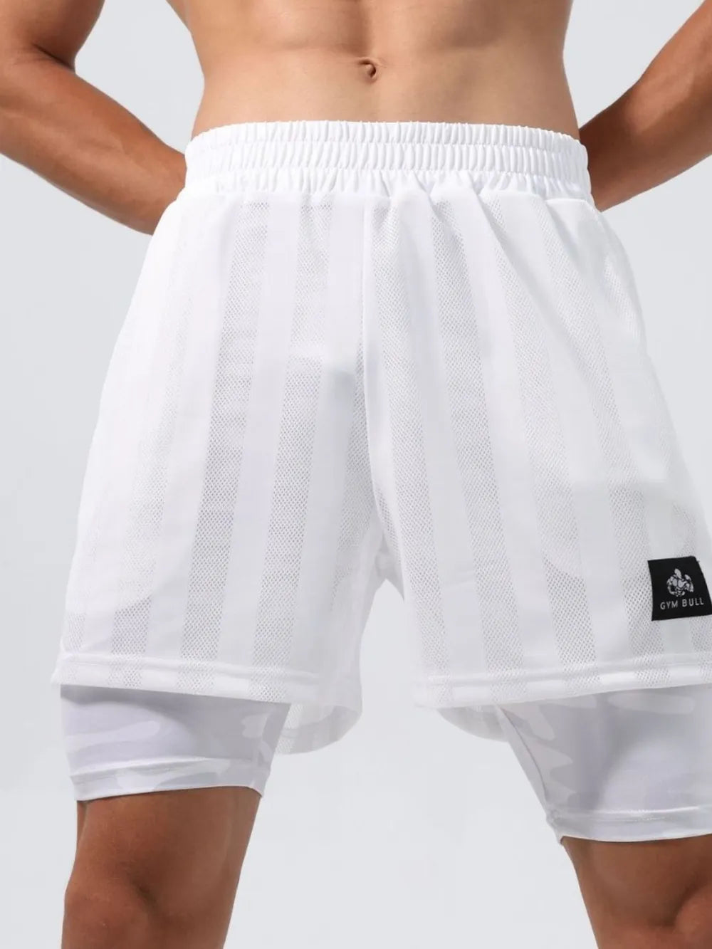 White layered mesh performance shorts with striped pattern and built-in liner.