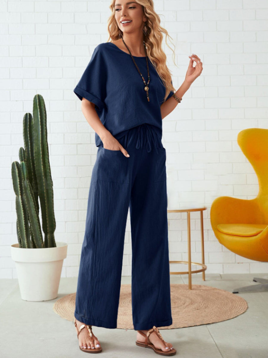 Dark blue linen co-ord set with wide leg pants and a relaxed top, featuring a drawstring waist.
