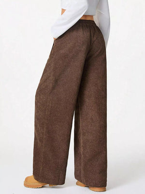 Brown corduroy wide-leg pants with drawstring waist and pockets.