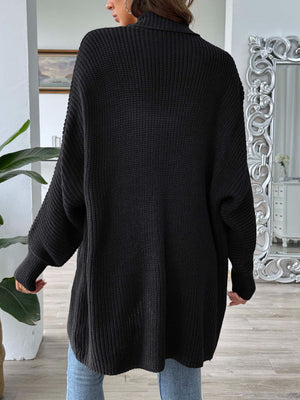 Black ribbed knit cardigan with pearl buttons, long sleeves, and a relaxed fit.