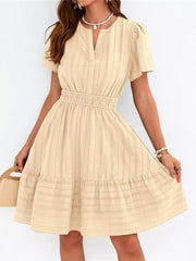 Apricot textured V-neck tiered dress with smocked waist and short puff sleeves.