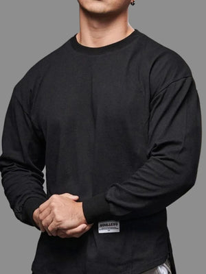 Black oversized long sleeve tee with curved hem and crew neck.