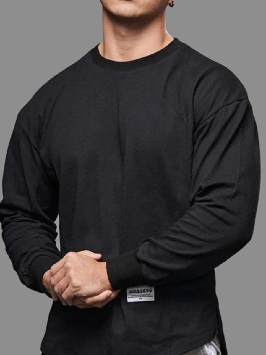 Black oversized long sleeve tee with curved hem and crew neck.