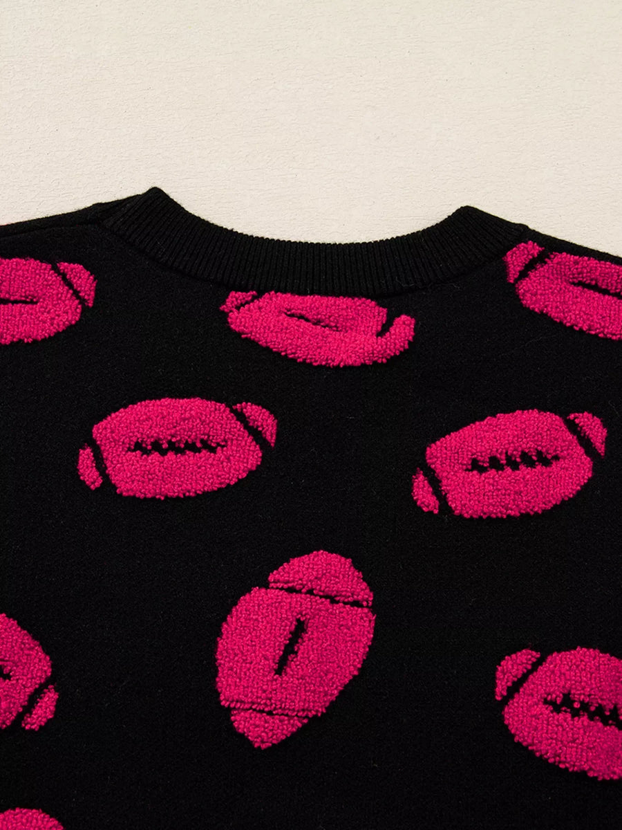 Black short-sleeve sweater with a playful all-over pink football pattern.