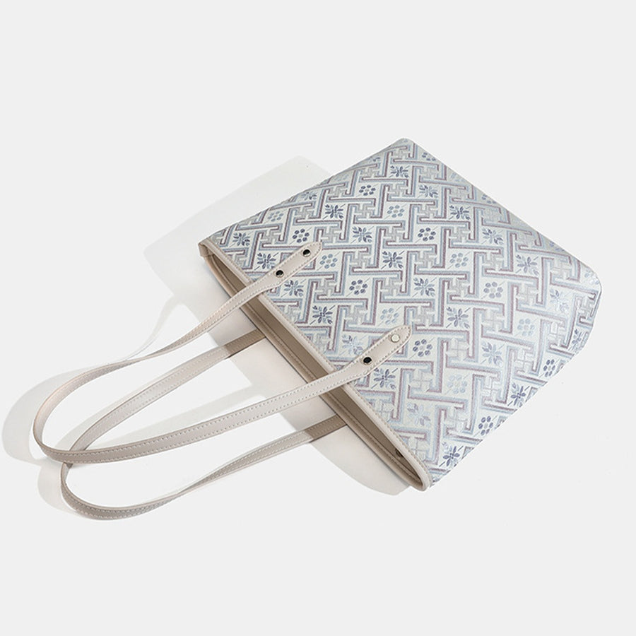 tote featuring geometric in light grey with Faux leather Imported Size &amp texture