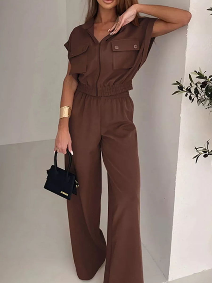 Brown zip-front collared short-sleeve cropped jumpsuit with elastic waist and wide-leg pants.