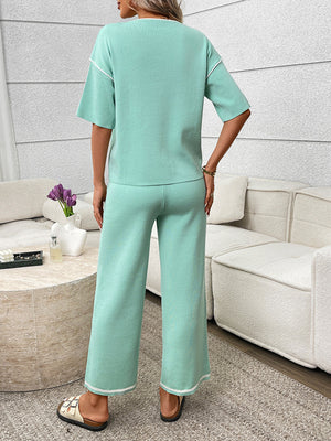 Light green relaxed fit loungewear set with crew neck top and wide leg pants, detailed with white piping.