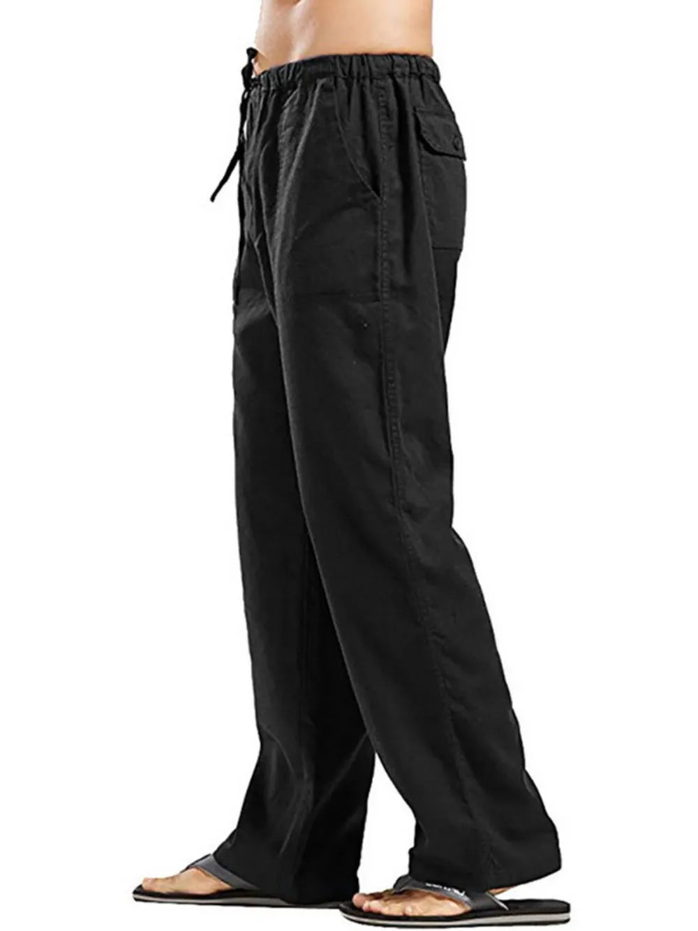 Black linen drawstring trousers with pockets and a relaxed fit.