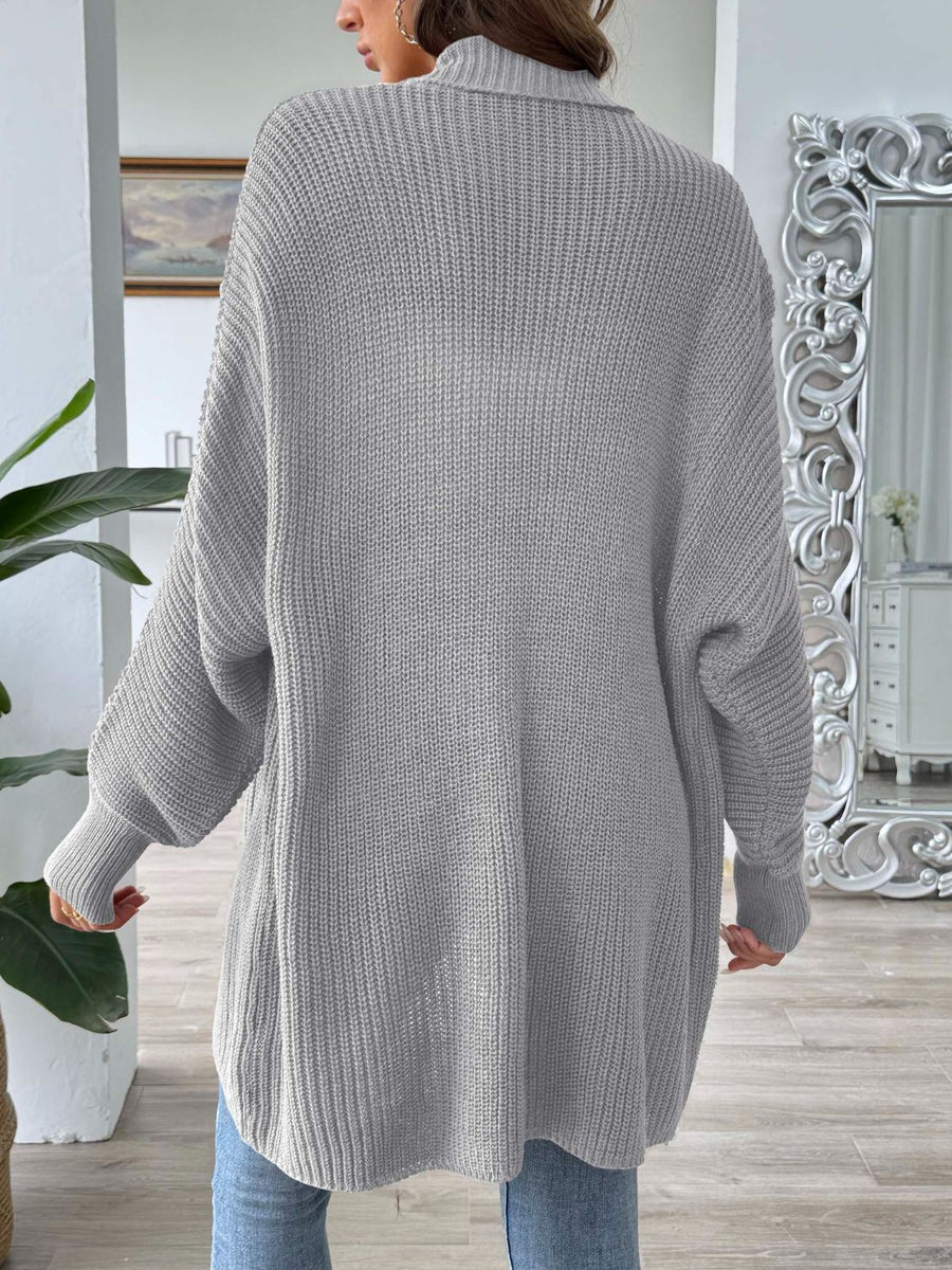 Gray ribbed knit cardigan with pearl buttons and a relaxed fit.