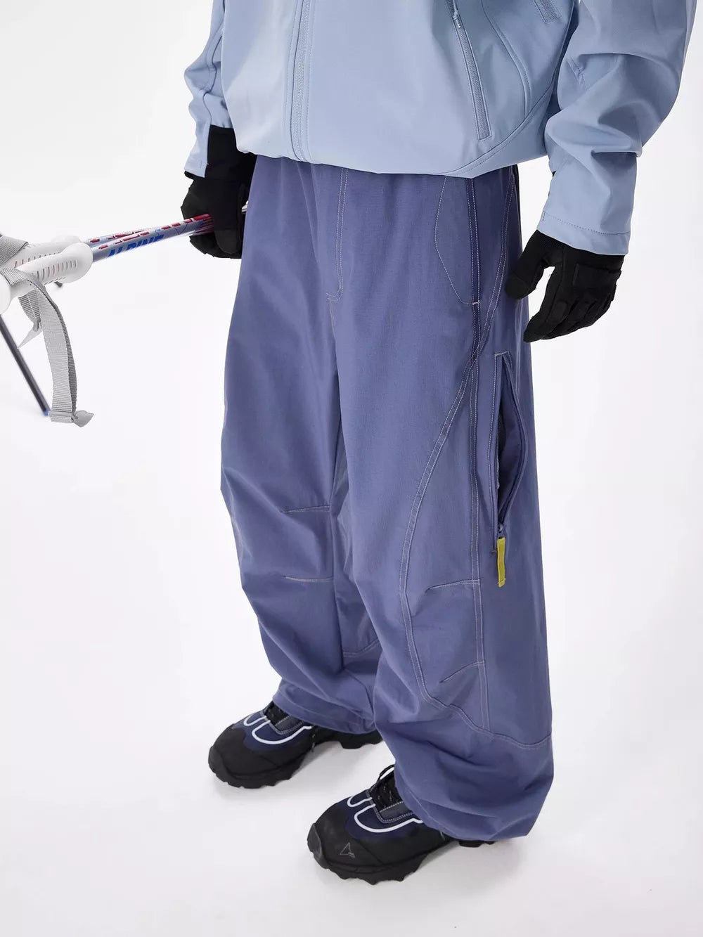 Men's blue loose fit cargo sweatpants with zippered pockets and contrast stitching.