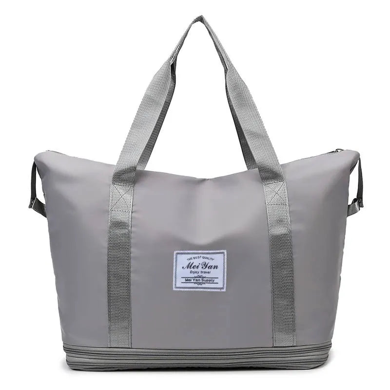 Gray expandable travel tote bag with contrast trim and zipper detail.
