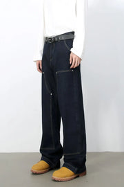 Dark carpenter jeans with a wide, relaxed fit and contrast stitching.