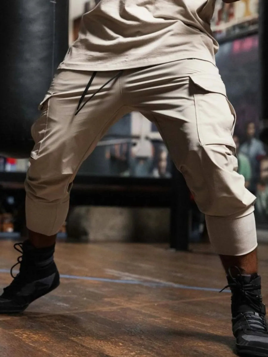 Khaki technical cargo joggers with ribbed cuffs and drawstring waist.