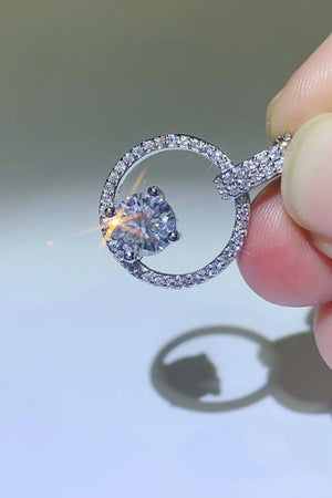 Silver halo moissanite circle pendant necklace with pave diamond accents.