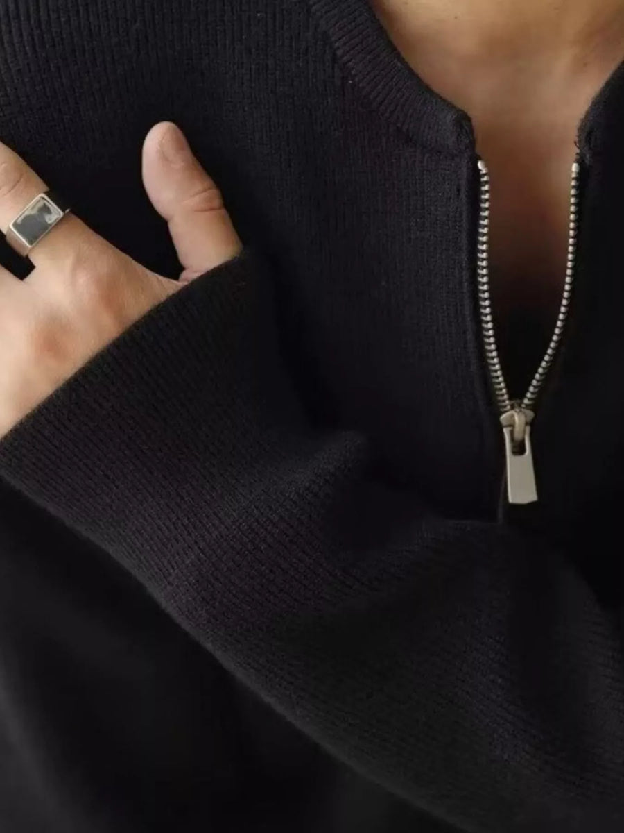 Black quarter zip relaxed fit pullover sweater with silver zipper detail.