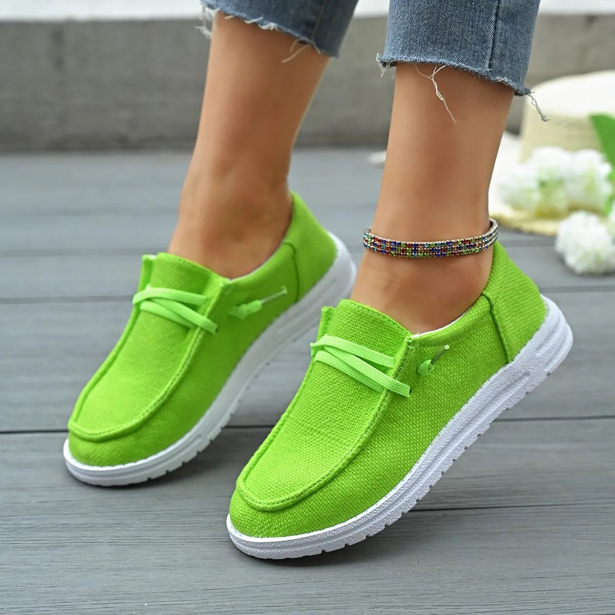 Lime green linen-blend boat shoes with white contrast sole and tie detail.