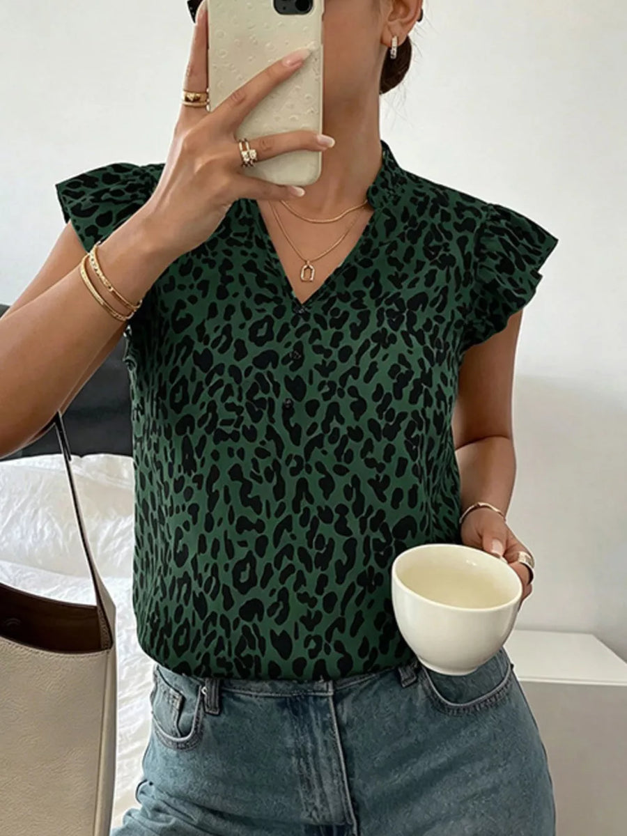 Green leopard print blouse with ruffled cap sleeves and a V-neckline.