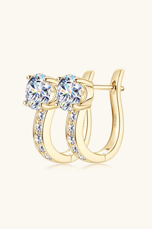 Gold pavé and solitaire hoop earrings with oval-cut stones and channel-set accents.