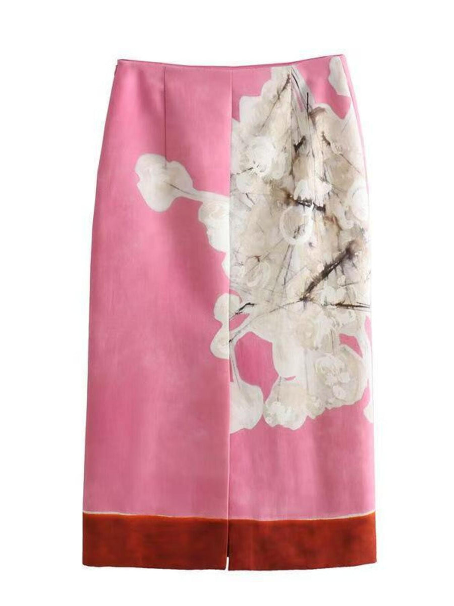 Vibrant floral print pencil skirt in pink with abstract white blossoms and a brown hem.