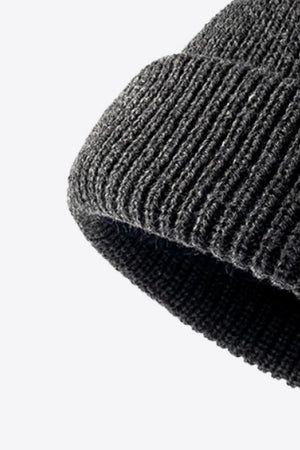 Folded edge ribbed knit beanie in dark gray acrylic.