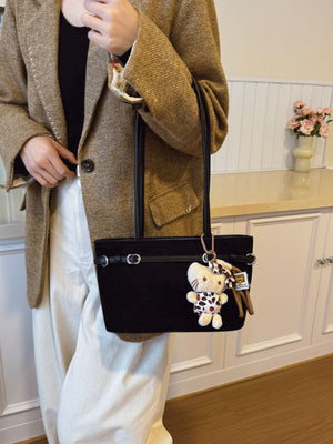 handbag in black featuring decorative buckle and boxy fit