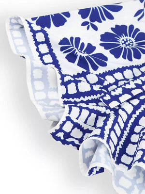 Blue floral strapless maternity romper with tie waist detail and ruffled hem.