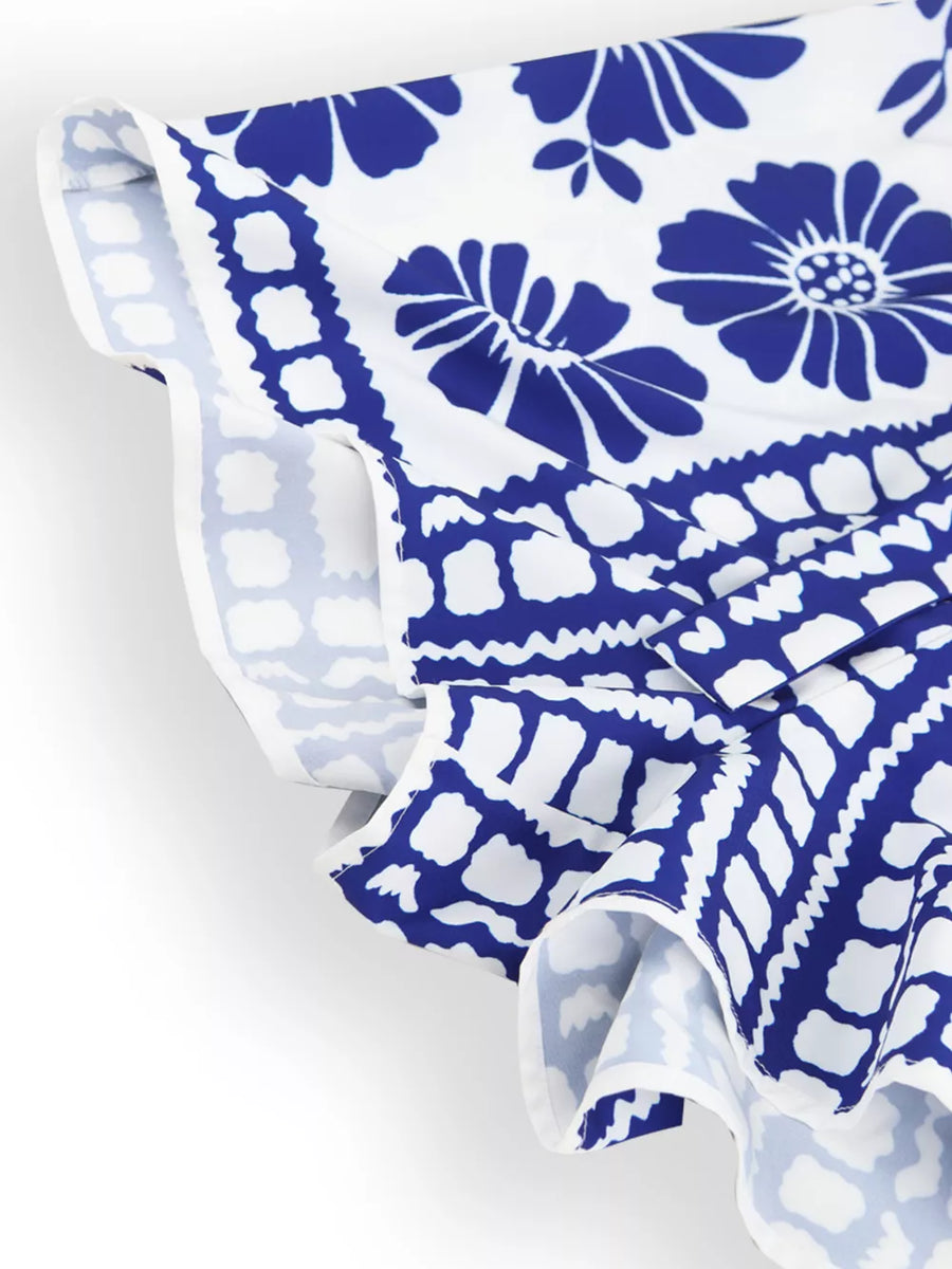 Blue floral strapless maternity romper with tie waist detail and ruffled hem.