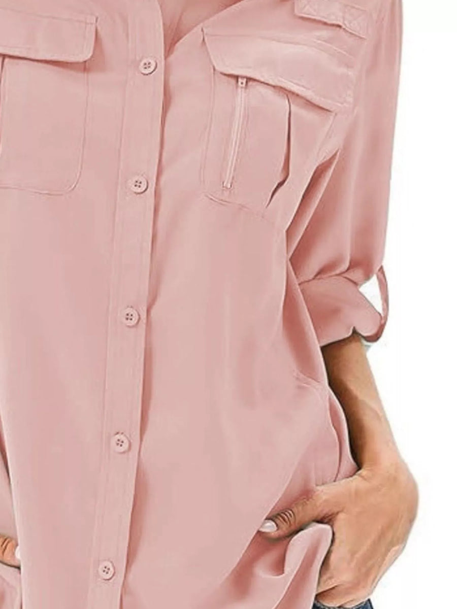 Pink roll-up sleeve button-up shirt with chest pockets and zipper detail.
