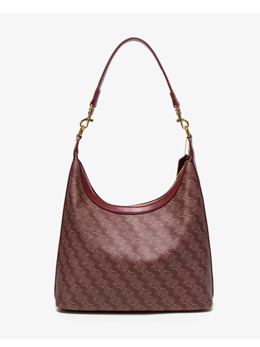 handbag in burgundy with geometric and adjustable strap
